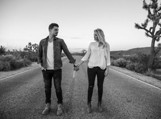 woman and man standing on concrete road