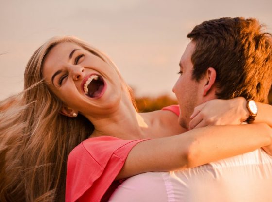 man hugging woman while smiling