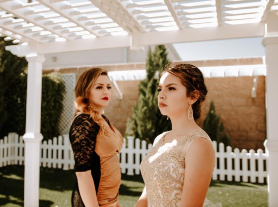 Two females wearing beautiful dresses