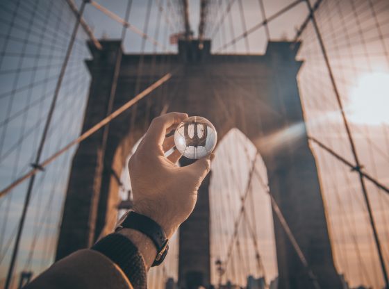 holding glass ball at Brooklyn Bridge