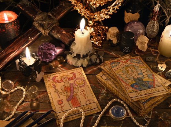 Mystic ritual with tarot cards, magic objects and candles