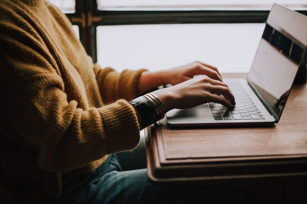 person typing on laptop