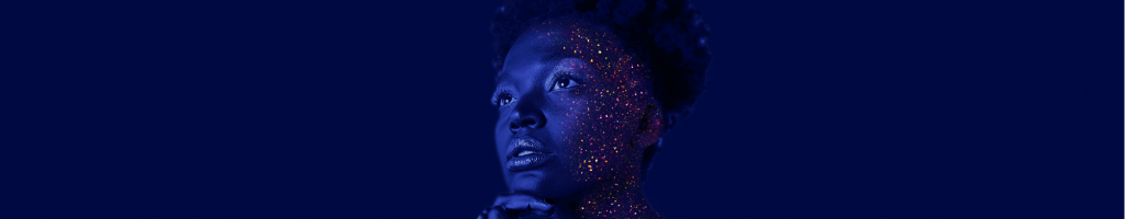 woman in blue lighting with glitter