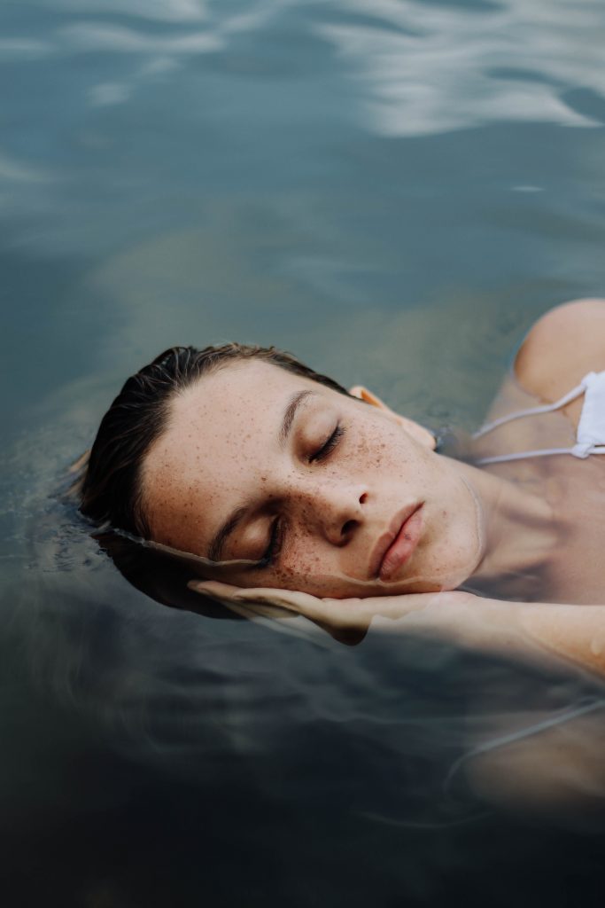 peaceful woman laying in water