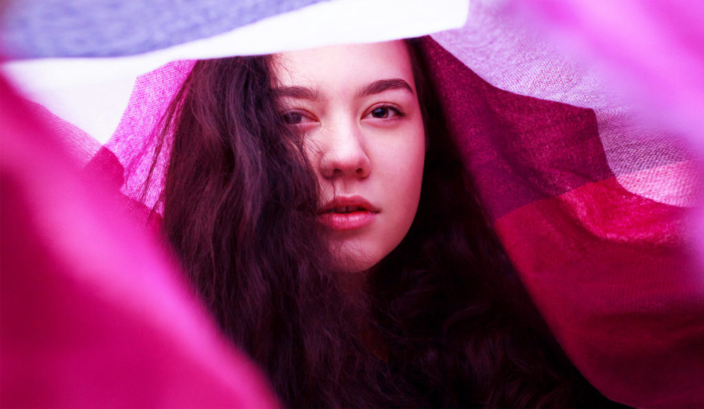 woman in pink light and pink blanket