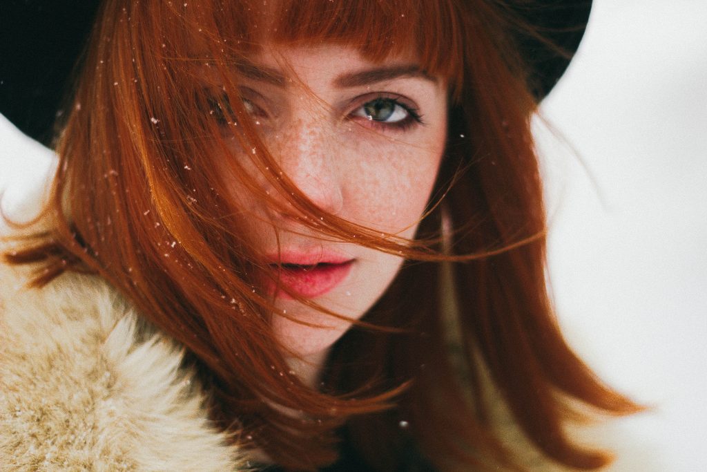 intense red headed woman in snow