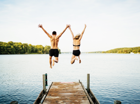couple jumping into lake