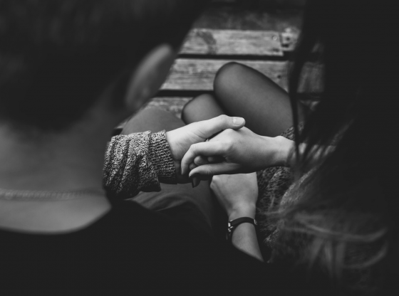 black and white photo of couple holding hands