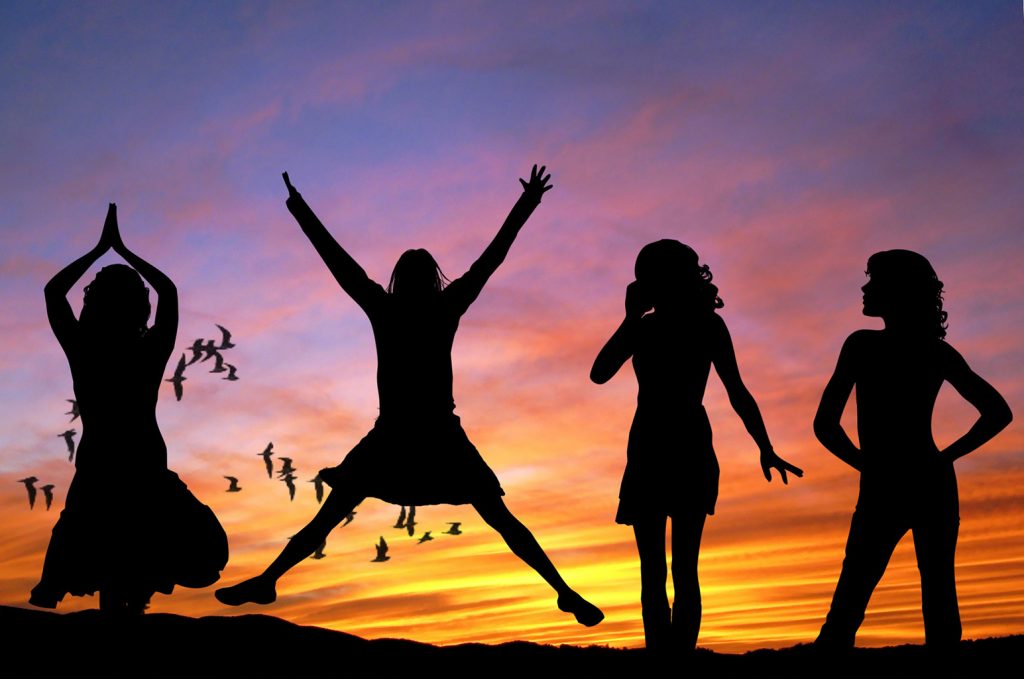 silhouette of women jumping
