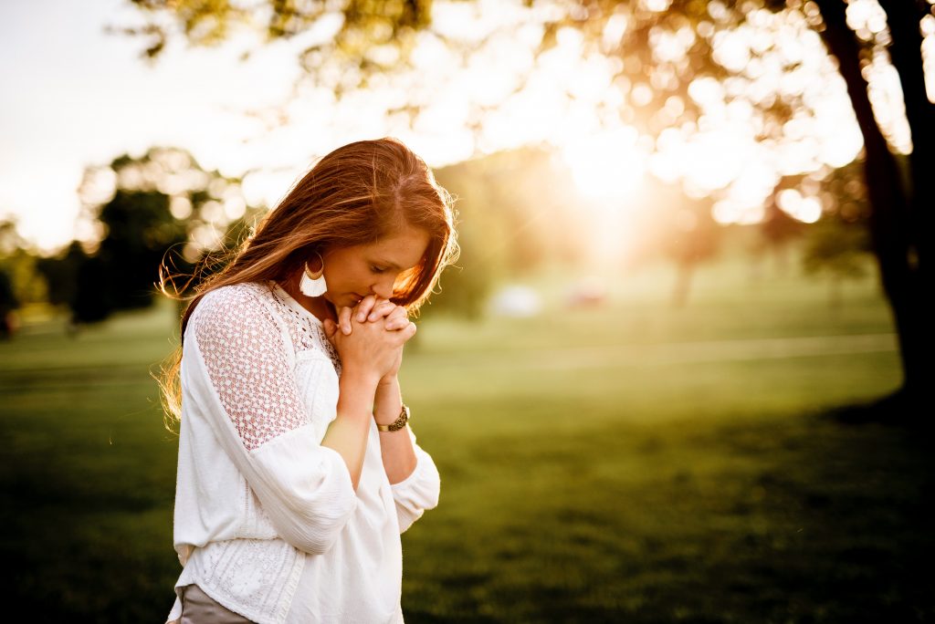 grateful woman praying in park