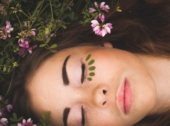 woman laying in flowers