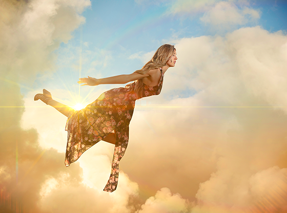 woman flying through the sky