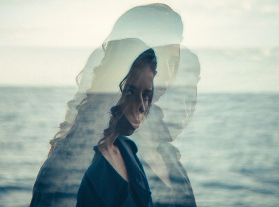 overlay of woman staring intensely by ocean