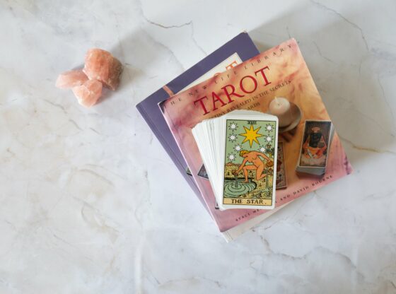 Tarot cards laid out on a table, with The Chariot prominently featured.