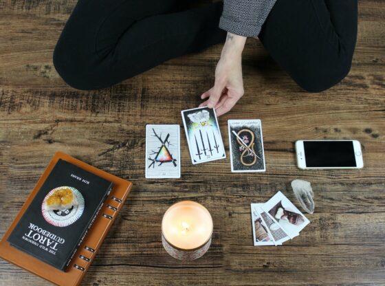 A woman is learning to read tarot.