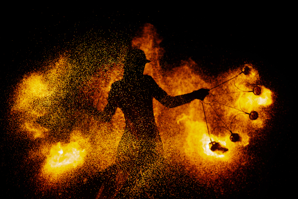 A fire dancer dancing with flames.