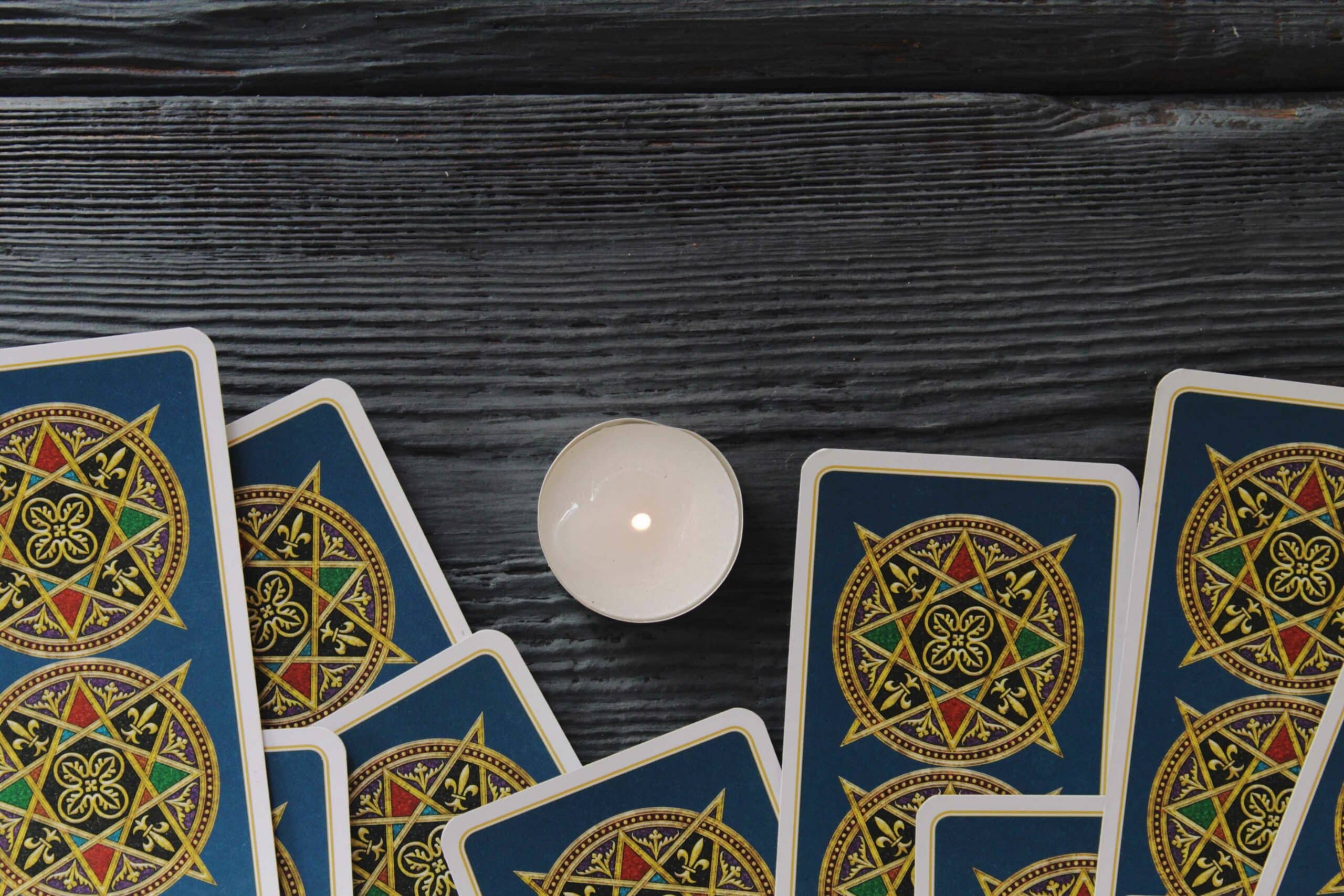 tarot cards and candle on a wooden table