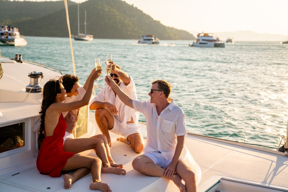 Capricorn friends making a toast on a boat for the 2024 new year.