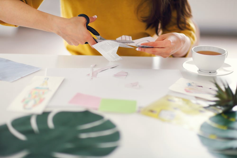 Close-up of a woman creating a vision board.