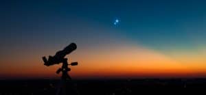 A telescope looking at a Venus conjunct Uranus synastry in the sky