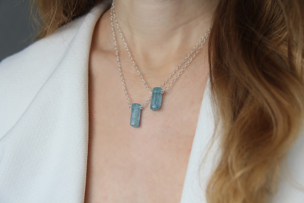 A woman wearing aquamarine birthstone jewelry